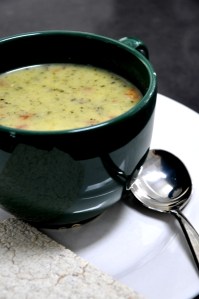 Creamy minted zucchini soup with tomato and white beans